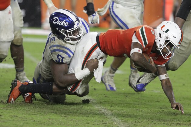 Miami quarterback N'Kosi Perry (5) is tackled by Duke defensive end Victor Dimukeje (51) during the second half of an NCAA college football game, Saturday, Nov. 3, 2018, in Miami Gardens, Fla. Duke won 20-12. (AP Photo/Lynne Sladky) Miami quarterback N'Kosi Perry (5) is tackled by Duke defensive end Victor Dimukeje (51) during the second half of an NCAA college football game, Saturday, Nov. 3, 2018, in Miami Gardens, Fla. Duke won 20-12. (AP Photo/Lynne Sladky)