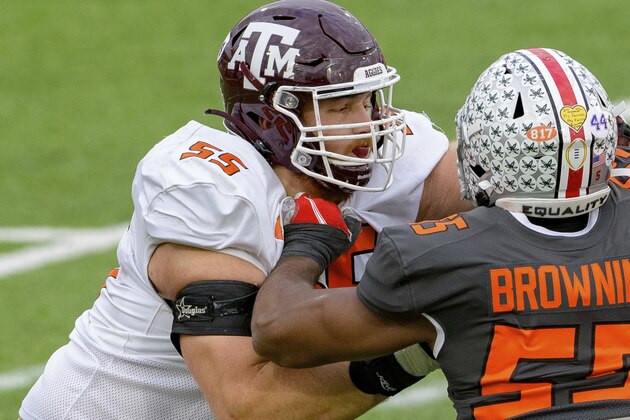 National Team offensive linebacker Baron Browning of Ohio State (55) battles American Team offensive lineman Carson Green of Texas A&M (55) during the NCAA Senior Bowl college football game in Mobile, Ala., Saturday, Jan. 30, 2021. (AP Photo/Matthew Hinton)