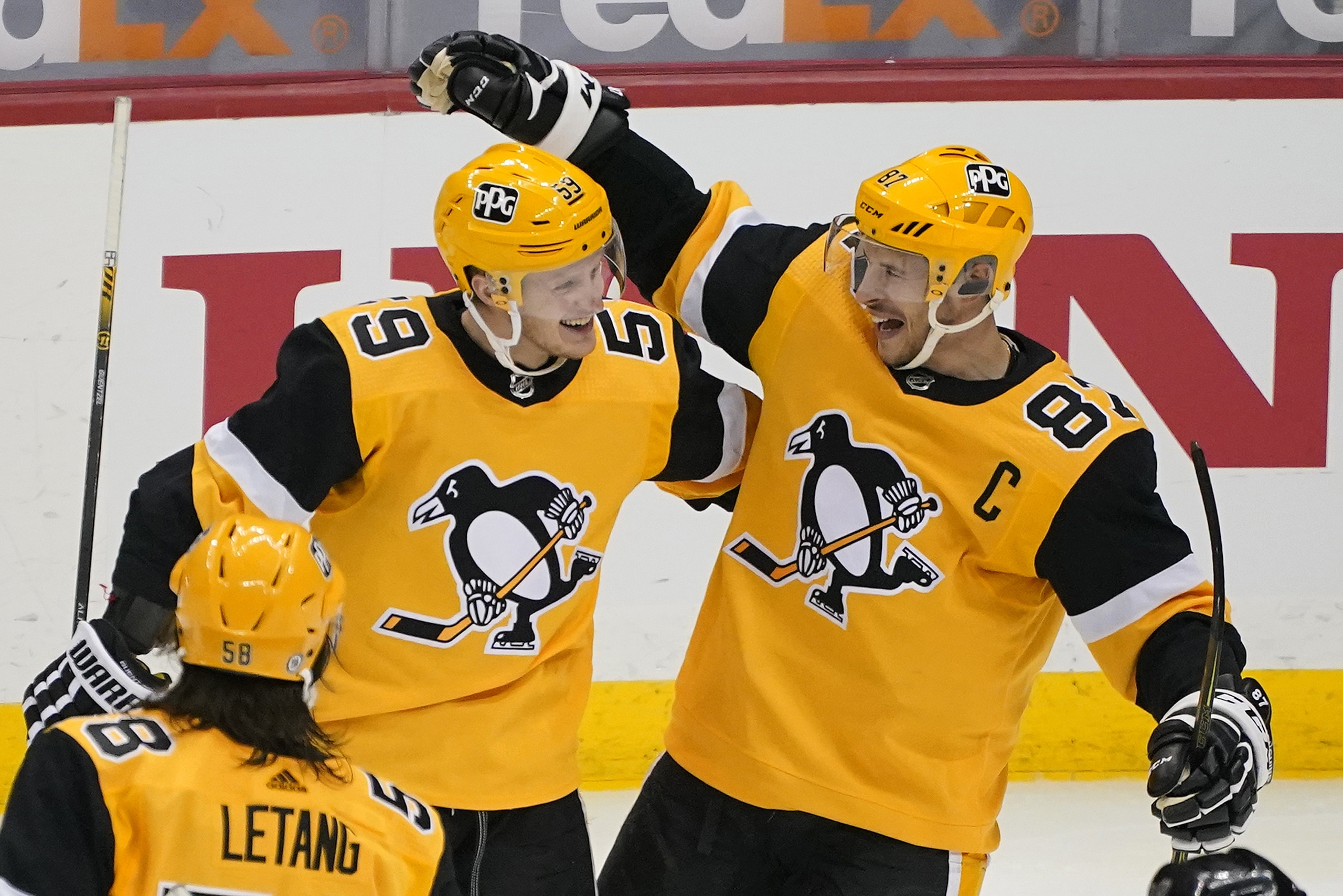 Pittsburgh Penguins' Jake Guentzel celebrates his goal with Sidney Crosby (87) during the third period of an NHL hockey game against the Boston Bruins in Pittsburgh, Sunday, April 25, 2021. The Penguins won 1-0.(AP Photo/Gene J. Puskar)