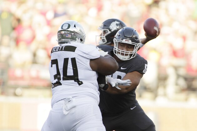 Washington State offensive lineman Frederick Mauigoa, right, blocks Oregon defensive lineman Jordon Scott (34) during the first half of an NCAA college football game in Pullman, Wash., Saturday, Oct. 20, 2018. (AP Photo/Young Kwak)
