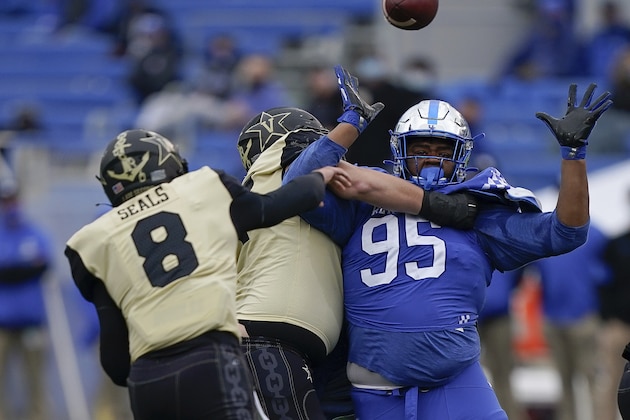 Kentucky defensive tackle Quinton Bohanna (95) pressures Vanderbilt quarterback Ken Seals (8) during the second half of an NCAA college football game, Saturday, Nov. 14, 2020, in Lexington, Ky. (AP Photo/Bryan Woolston)