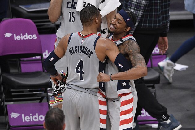 Washington Wizards guard Russell Westbrook (4) and guard Bradley Beal, right, react after an NBA basketball game against the Golden State Warriors, Wednesday, April 21, 2021, in Washington. The Wizards won 118-114. (AP Photo/Nick Wass)