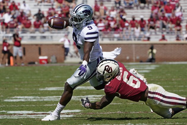Kansas State running back Jacardia Wright (9) is chased by Oklahoma defensive back Tre Brown (6) during an NCAA college football game Saturday, Sept. 26, 2020, in Norman, Okla. (AP Photo/Sue Ogrocki)