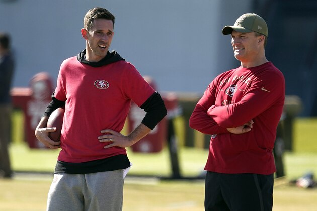 FILE- In this Jan. 24, 2020, file photo, San Francisco 49ers general manager John Lynch, right, and head coach Kyle Shanahan, left, watch as players practice at the team's NFL football training facility in Santa Clara, Calif. The San Francisco 49ers have agreed on a one-year contract with free agent tight end Jordan Reed,  Lynch announced Monday, Aug. 3, 2020. (AP Photo/Tony Avelar, File)