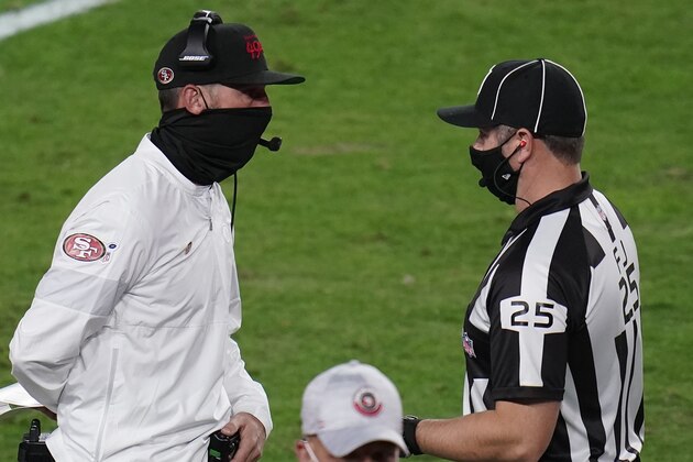 San Francisco 49ers head coach Kyle Shanahan talks with side judge Bob Waggoner (25) during the first half of an NFL football game against the Buffalo Bills, Monday, Dec. 7, 2020, in Glendale, Ariz. (AP Photo/Ross D. Franklin)