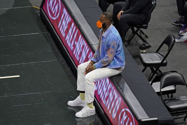 Los Angeles Lakers forward LeBron James watches his teammates play during the second half of an NBA basketball game against the Orlando Magic, Monday, April 26, 2021, in Orlando, Fla. (AP Photo/John Raoux)