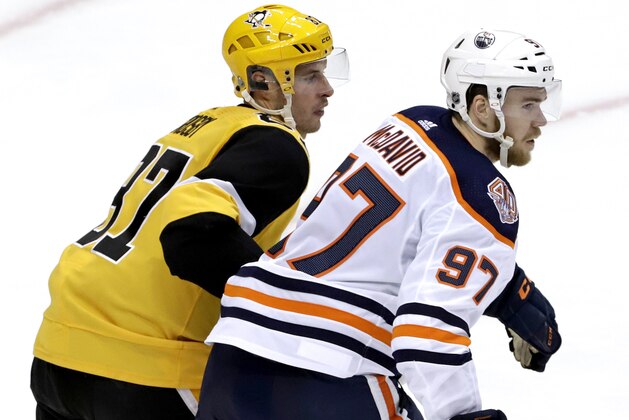 Pittsburgh Penguins' Sidney Crosby (87) and Edmonton Oilers' Connor McDavid play during the third period of an NHL hockey game in Pittsburgh, Wednesday, Feb. 13, 2019. The Penguins won 3-1.(AP Photo/Gene J. Puskar)