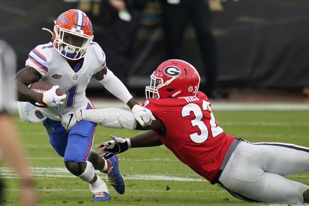 Florida wide receiver Kadarius Toney (1) makes a move to get around Georgia linebacker Monty Rice (32) during the first half of an NCAA college football game, Saturday, Nov. 7, 2020, in Jacksonville, Fla. (AP Photo/John Raoux)