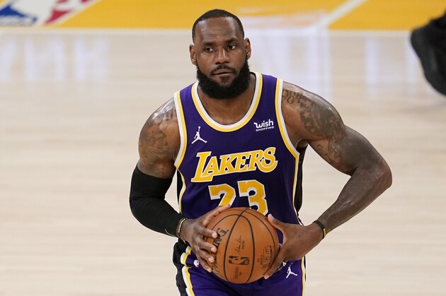 Los Angeles Lakers forward LeBron James dribbles during an NBA basketball game against the Charlotte Hornets Thursday, March 18, 2021, in Los Angeles. (AP Photo/Marcio Jose Sanchez)