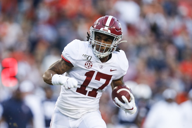 Alabama wide receiver Jaylen Waddle (17) carries the ball in for a touchdown after a reception during the first half of an NCAA college football game against Auburn Saturday, Nov. 30, 2019, in Auburn, Ala. (AP Photo/Butch Dill)