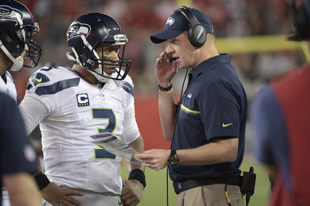 Seattle Seahawks quarterback Russell Wilson (3) talks with offensive coordinator Darrell Bevell on the sideline during a timeout in the second half of an NFL football game against the Tampa Bay Buccaneers in Tampa, Fla., Sunday, Nov. 27, 2016. The Buccaneers won 14-5. (AP Photo/Phelan M. Ebenhack)