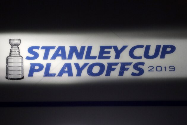 FILE - In this April 26, 2019, file photo, the Stanley Cup playoffs logo is seen on the ice during a light and sound check prior to Game 1 of an NHL hockey second-round playoff series between the New York Islanders and the Carolina Hurricanes, in New York. The NHL nailed down the final details of a playoff format if the season can resume on the same day word came out that another player has tested positive for the coronavirus.(AP Photo/Julio Cortez, File)