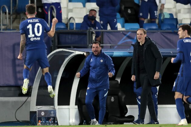 Chelsea's head coach Thomas Tuchel, 2nd right, reacts as Chelsea's Christian Pulisic, left, celebrates after scoring the opening goal during the Champions League semifinal first leg soccer match between Real Madrid and Chelsea at the Alfredo di Stefano stadium in Madrid, Spain, Tuesday, April 27, 2021. (AP Photo/Bernat Armangue)