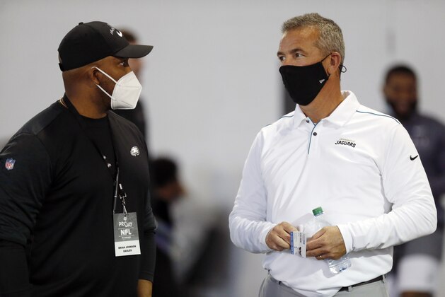 Jackson Jaguars coach and former Ohio State coach Urban Meyer talks with Eagles assistant Brian Johnson during an NFL Pro Day at Ohio State University Tuesday, March 30, 2021 in Columbus, Ohio. (AP Photo/Paul Vernon)