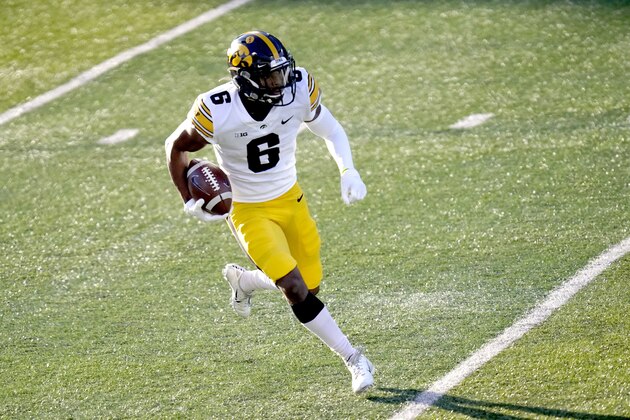 Iowa wide receiver Ihmir Smith-Marsette carries the ball during the first half of an NCAA college football game against Illinois Saturday, Dec. 5, 2020, in Champaign , Ill. (AP Photo/Charles Rex Arbogast)