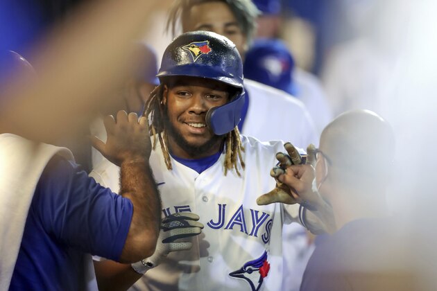 Toronto Blue Jays' Vladimir Guerrero Jr. is congratulated after his second home run against the Washington Nationals during the fifth inning of a baseball game Thursday, April 27, 2021, in Dunedin, Fla. (AP Photo/Mike Carlson)