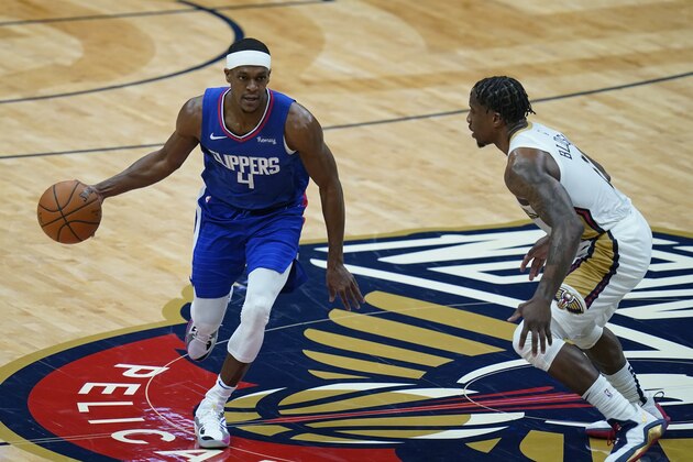 LA Clippers guard Rajon Rondo (4) works the ball against New Orleans Pelicans guard Eric Bledsoe in the first half of an NBA basketball game in New Orleans, Monday, April 26, 2021. (AP Photo/Gerald Herbert)