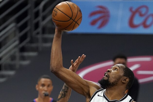Brooklyn Nets forward Kevin Durant (7) grabs a rebound away from Toronto Raptors center Khem Birch (24) during the first half of an NBA basketball game Tuesday, April 27, 2021, in Tampa, Fla. (AP Photo/Chris O'Meara)