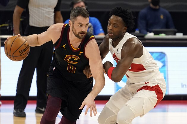 Cleveland Cavaliers forward Kevin Love (0) drives around Toronto Raptors forward OG Anunoby (3) during the first half of an NBA basketball game Monday, April 26, 2021, in Tampa, Fla. (AP Photo/Chris O'Meara)