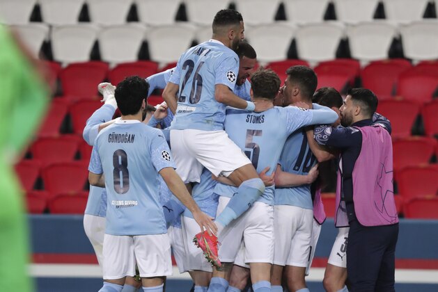 Manchester City's Kevin De Bruyne, 2nd left, celebrates with teammates after scoring his sides first goal during the Champions League semifinal first leg soccer match between Paris Saint Germain and Manchester City at the Parc des Princes stadium, in Paris, France , Wednesday, April 28, 2021. (AP Photo/Thibault Camus)