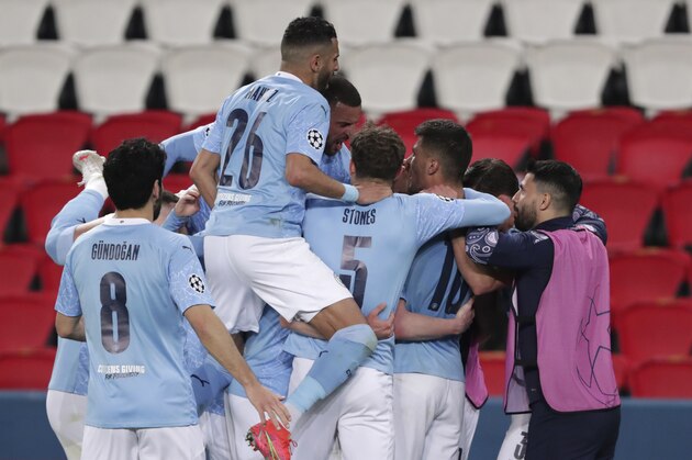 Manchester City's Kevin De Bruyne, 2nd left, celebrates with teammates after scoring his sides first goal during the Champions League semifinal first leg soccer match between Paris Saint Germain and Manchester City at the Parc des Princes stadium, in Paris, France , Wednesday, April 28, 2021. (AP Photo/Thibault Camus)