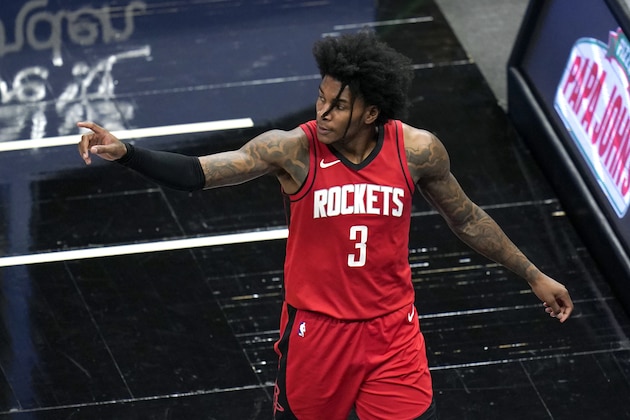 Houston Rockets guard Kevin Porter Jr. (3) points to teammates as he leaves the court after fouling out during the second half of an NBA basketball game against the Orlando Magic, Sunday, April 18, 2021, in Orlando, Fla. (AP Photo/John Raoux)
