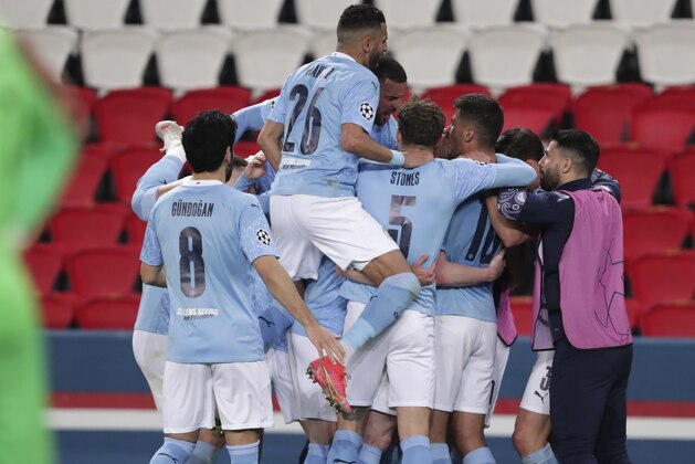 Manchester City's Kevin De Bruyne, 2nd left, celebrates with teammates after scoring his sides first goal during the Champions League semifinal first leg soccer match between Paris Saint Germain and Manchester City at the Parc des Princes stadium, in Paris, France , Wednesday, April 28, 2021. (AP Photo/Thibault Camus)