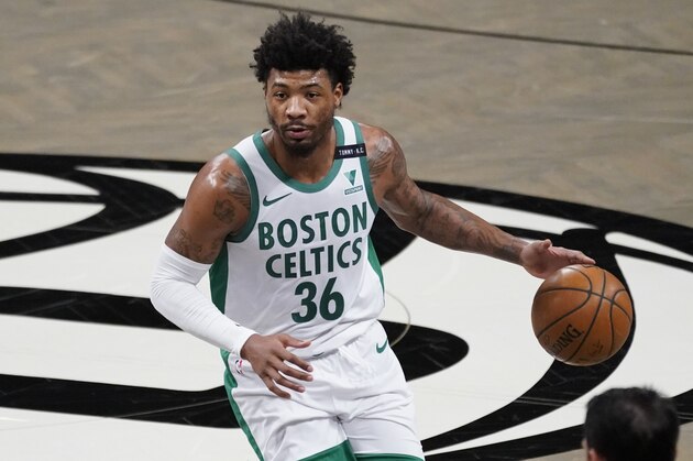 Boston Celtics guard Marcus Smart handles the ball during the first half of an NBA basketball game against the Brooklyn Nets, Friday, April 23, 2021, in New York. (AP Photo/Mary Altaffer)