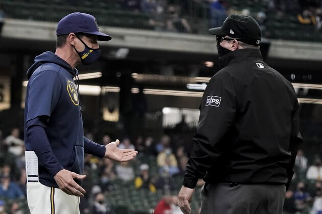 Milwaukee Brewers manager Craig Counsell argues a call with firast base upmire Marty Foster during the second inning of a baseball game against the Miami Marlins Wednesday, April 28, 2021, in Milwaukee. (AP Photo/Morry Gash)