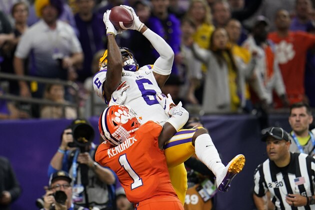 LSU wide receiver Terrace Marshall Jr. catches a touchdown pass over Clemson cornerback Derion Kendrick during the second half of a NCAA College Football Playoff national championship game Monday, Jan. 13, 2020, in New Orleans. (AP Photo/David J. Phillip)