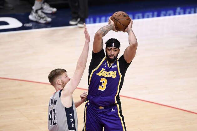 Los Angeles Lakers forward Anthony Davis (3) looks to pass against Washington Wizards forward Davis Bertans (42) during the second half of an NBA basketball game, Wednesday, April 28, 2021, in Washington. (AP Photo/Nick Wass)