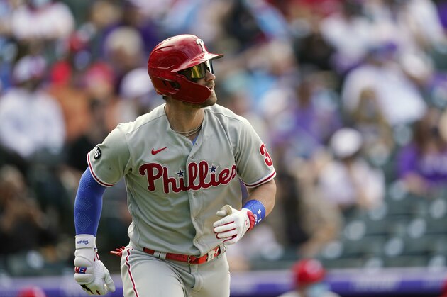 Philadelphia Phillies' Bryce Harper heads up the first-base line after flying out againt Colorado Rockies relief pitcher Robert Stephenson in the eighth inning of a baseball game Sunday, April 25, 2021, in Denver. Colorado won 12-2. (AP Photo/David Zalubowski)