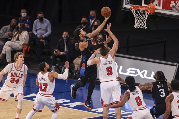 New York Knicks guard Derrick Rose (4) shoots next to Chicago Bulls center Nikola Vucevic (9) during the fourth quarter of an NBA basketball game Wednesday, April 28, 2021, in New York. (Vincent Carchietta/Pool Photo via AP)