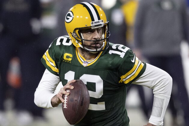 FILE - In this Jan. 16, 2021, file photo, Green Bay Packers quarterback Aaron Rodgers (12) runs during an NFL divisional playoff football game against the Los Angeles Rams in Green Bay, Wis. Packers general manager Brian Gutekunst says the team remains committed to Rodgers “for the foreseeable future” one year after trading up in the first round to draft the three-time MVP’s potential successor. (AP Photo/Jeffrey Phelps, File)