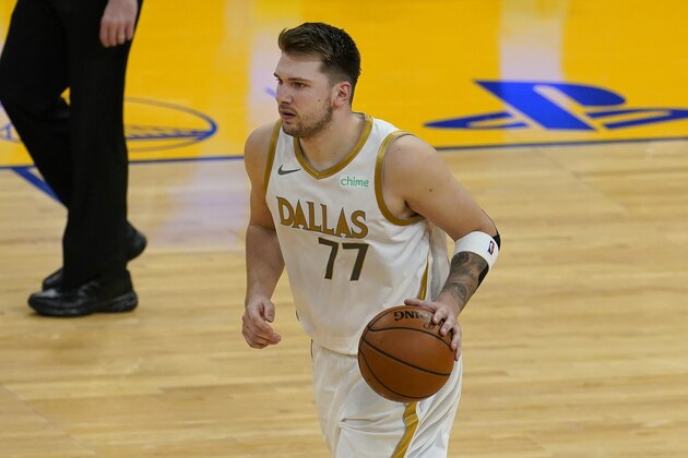 Dallas Mavericks guard Luka Doncic dribbles the ball during the second half of the team's NBA basketball game against the Golden State Warriors in San Francisco, Tuesday, April 27, 2021. (AP Photo/Jeff Chiu)