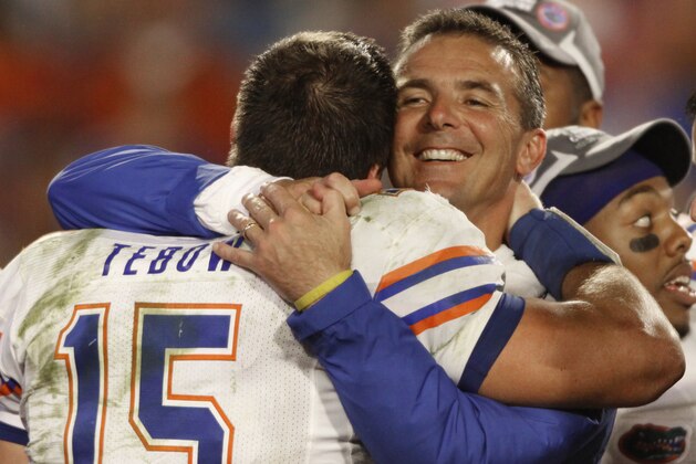 FILE - In this Jan. 8, 2009, file photo, Florida's Tim Tebow is hugged by coach Urban Meyer after Florida defeated Oklahoma 24-14 in the BCS Championship NCAA college football game, in Miami. The Associated Press has been ranking the best teams in college football for the last 80 seasons. (AP Photo/Chris O'Meara, File)