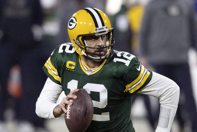 FILE - In this Jan. 16, 2021, file photo, Green Bay Packers quarterback Aaron Rodgers (12) runs during an NFL divisional playoff football game against the Los Angeles Rams in Green Bay, Wis. Packers general manager Brian Gutekunst says the team remains committed to Rodgers “for the foreseeable future” one year after trading up in the first round to draft the three-time MVP’s potential successor. (AP Photo/Jeffrey Phelps, File)