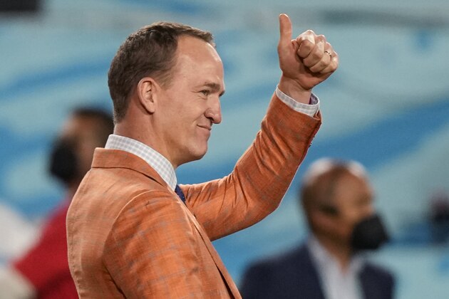 Former quarterback Peyton Manning motions to the crowd during the NFL Super Bowl 55 football game between the Tampa Bay Buccaneers and the Kansas City Chiefs, Sunday, Feb. 7, 2021, in Tampa, Fla. (AP Photo/David J. Phillip)