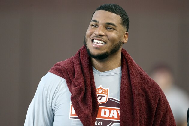 FILE - Christian Darrisaw smiles after completing a set of offensive line drills during Virginia Tech Pro Day in Blacksburg, Va., in this Friday, March 26, 2021, file photo. Darrisaw is a possible first round pick in the NFL Draft, April 29-May 1, 2021, in Cleveland. (AP Photo/Matt Gentry, File)