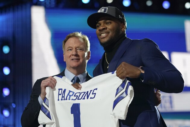 Penn State linebacker Micah Parsons, right, holds a team jersey with NFL Commissioner Roger Goodell after the was chosen by the Dallas Cowboys with the 12th pick in the NFL football draft Thursday, April 29, 2021, in Cleveland. (AP Photo/Tony Dejak) Penn State linebacker Micah Parsons, right, holds a team jersey with NFL Commissioner Roger Goodell after the was chosen by the Dallas Cowboys with the 12th pick in the NFL football draft Thursday, April 29, 2021, in Cleveland. (AP Photo/Tony Dejak)