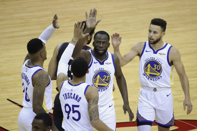 Golden State Warriors' Draymond Green (23) high-fives Kent Bazemore, left, Stephen Curry (30) and Juan Toscano-Anderson (95) during the first quarter against the Houston Rockets in an NBA basketball game Wednesday, March 17, 2021, in Houston. (Carmen Mandato/Pool Photo via AP)