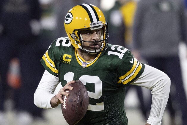 FILE - In this Jan. 16, 2021, file photo, Green Bay Packers quarterback Aaron Rodgers (12) runs during an NFL divisional playoff football game against the Los Angeles Rams in Green Bay, Wis. Packers general manager Brian Gutekunst says the team remains committed to Rodgers “for the foreseeable future” one year after trading up in the first round to draft the three-time MVP’s potential successor. (AP Photo/Jeffrey Phelps, File)