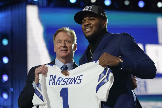 Penn State linebacker Micah Parsons, right, holds a team jersey with NFL Commissioner Roger Goodell after the was chosen by the Dallas Cowboys with the 12th pick in the NFL football draft Thursday, April 29, 2021, in Cleveland. (AP Photo/Tony Dejak)