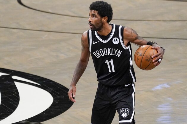 Brooklyn Nets guard Kyrie Irving handles the ball during the second half of an NBA basketball game against the Boston Celtics, Friday, April 23, 2021, in New York.The Nets won 109-104. (AP Photo/Mary Altaffer)