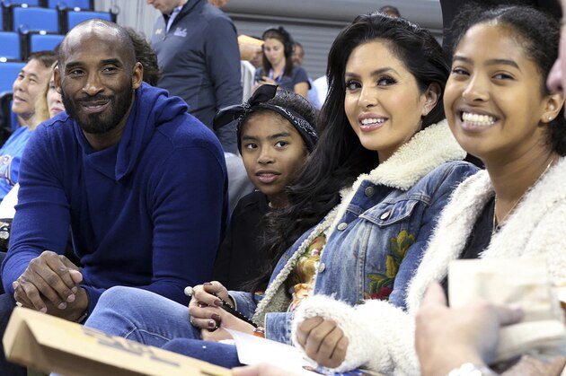 FILE - In this Nov. 21, 2017, file photo, from left, Los Angeles Lakers legend Kobe Bryant, his daughter Gianna Maria-Onore Bryant, wife Vanessa and daughter Natalia Diamante Bryant are seen before an NCAA college women's basketball game between Connecticut and UCLA, in Los Angeles. Vanessa Bryant says she is focused on “finding the light in darkness” in an emotional story in People magazine. She details how she attempts to push forward after her husband, Kobe Bryant, and daughter Gigi died in a helicopter crash in early 2020. (AP Photo/Reed Saxon, File)