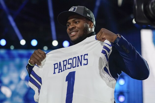Penn State linebacker Micah Parsons holds a team jersey after the was chosen by the Dallas Cowboys with the 12th pick in the NFL football draft Thursday, April 29, 2021, in Cleveland. (AP Photo/Tony Dejak)