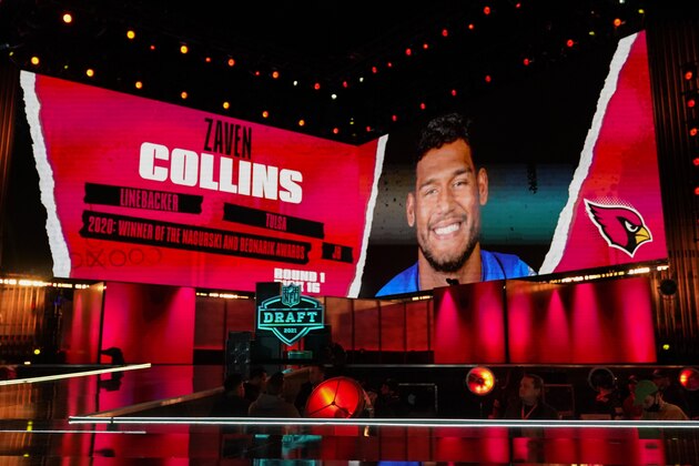 An image of Tulsa linebacker Zaven Collins is displayed on stage after he was chosen by the Arizona Cardinals with the 16 pick in the first round of the NFL football draft Thursday April 29, 2021, in Cleveland. (AP Photo/Tony Dejak)