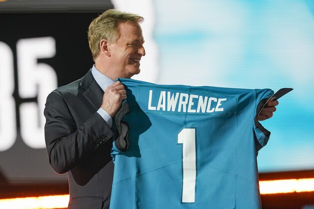 NFL Commissioner Roger Goodell holds a Jacksonville Jaguars jersey as he announces that the Jaguars had chosen Clemson quarterback Trevor Lawrence with the first pick in the NFL football draft, Thursday April 29, 2021, in Cleveland. (AP Photo/Tony Dejak)