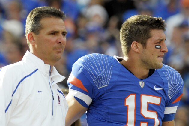 Florida quarterback Tim Tebow, right, fights back tears after embracing head coach Urban Meyer during the introduction of seniors before an NCAA college football game against Florida State in Gainesville, Fla., Saturday, Nov. 28, 2009. (AP Photo/Phelan M. Ebenhack)