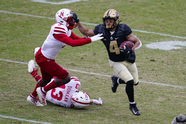 Purdue wide receiver Rondale Moore (4) holds off Nebraska linebacker Will Honas (3) during the first quarter of an NCAA college football game in West Lafayette, Ind., Saturday, Dec. 5, 2020. (AP Photo/Michael Conroy)
